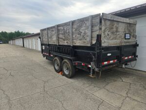 High-capacity dumpster trailer rental in Belding, MI with tall wood walls